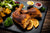 Roasted chicken on a plate with lemon and sauces.